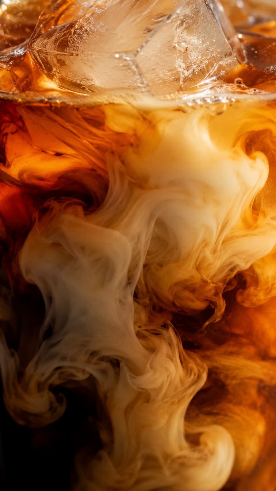 Cream swirling into iced cold brew